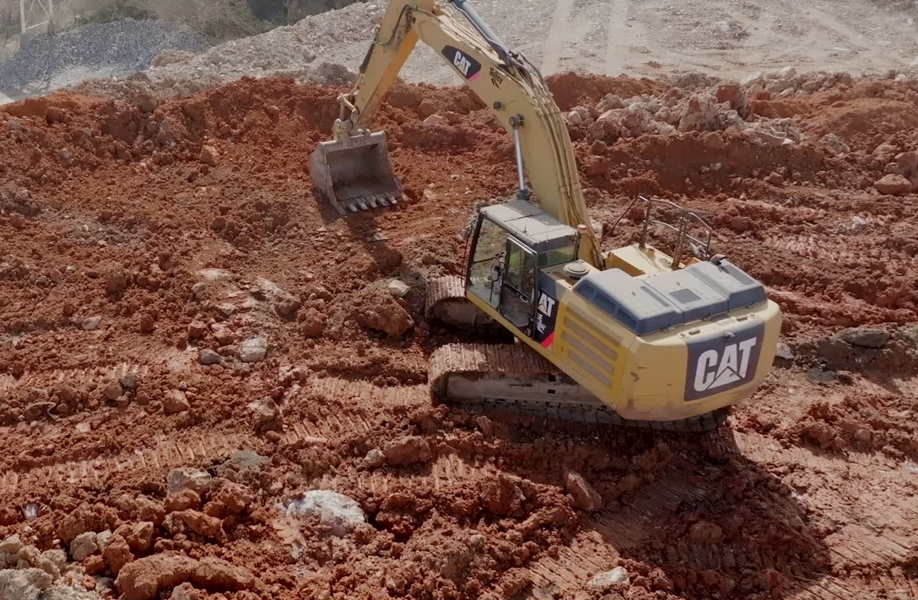 Excavator working broken rock and rubble