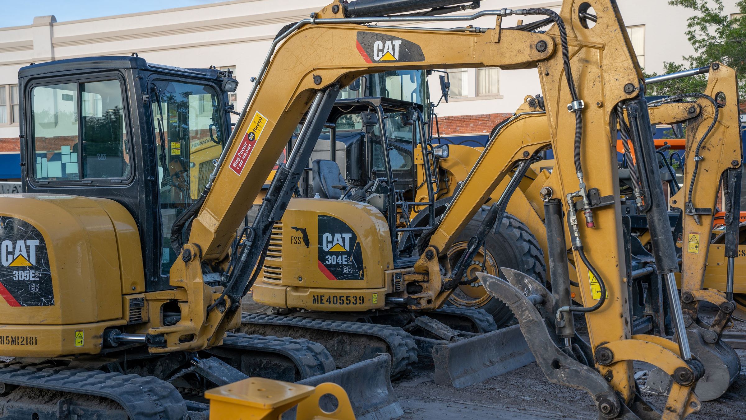 Caterpillar excavators lined up on a contractor yard