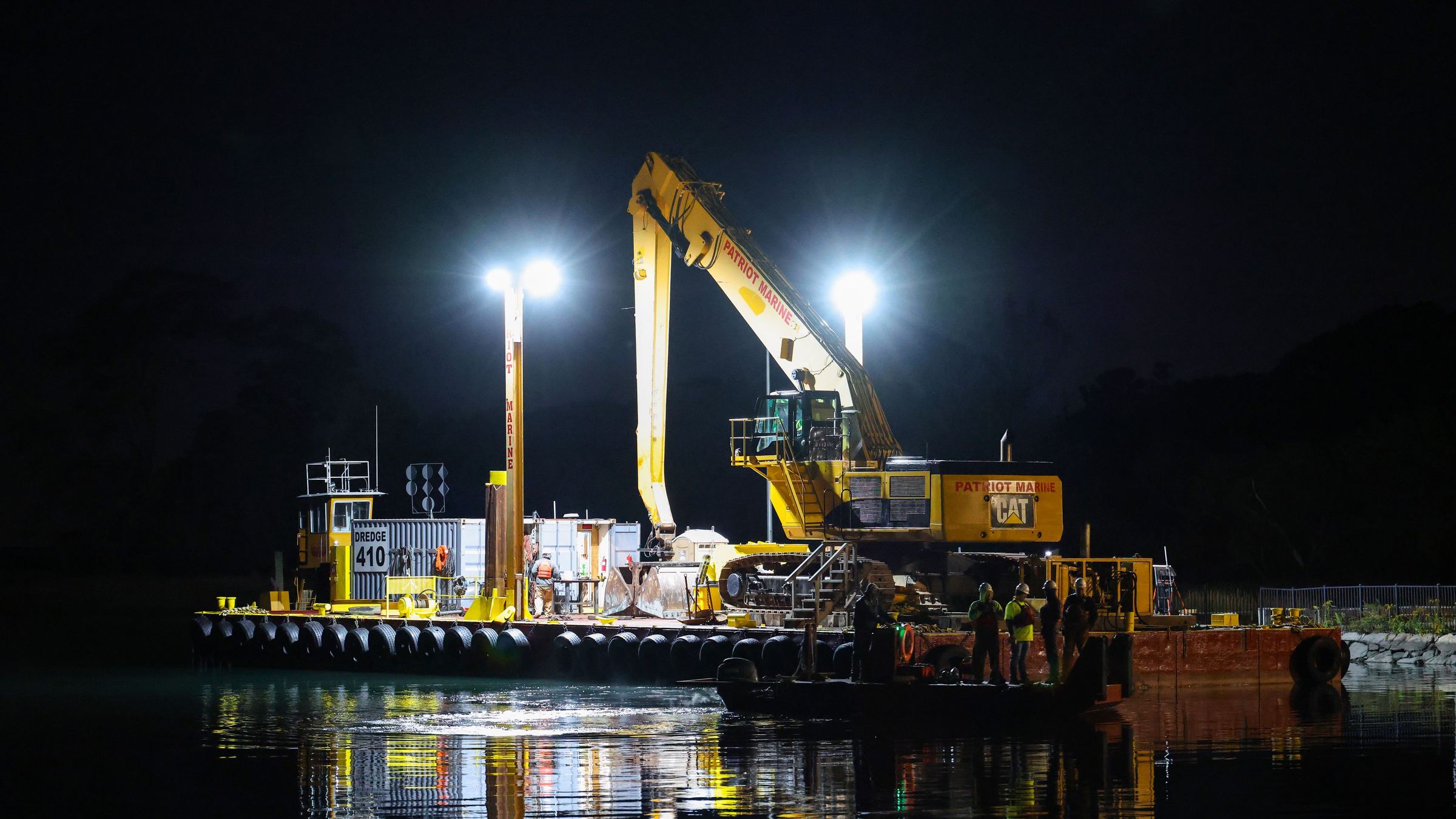 Heavy equipment working under floodlights at night